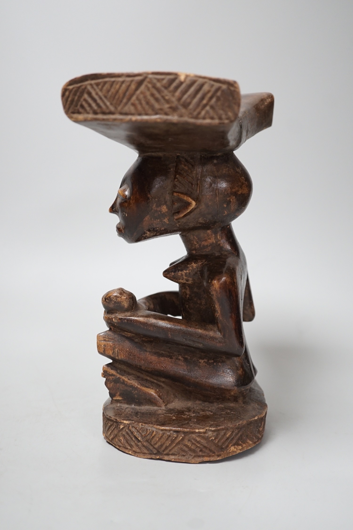 An African tribal carved wood fertility figure headrest, possibly Songye,. 24cm tall